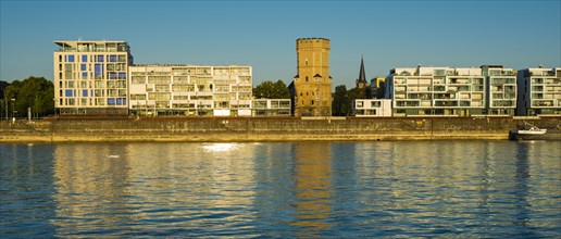 Houses with Bayenturm defence tower by the river Rhein