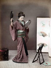 Geisha looking into mirror
