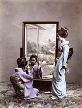 Two Geishas in front of mirror