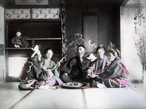 Four women and man making music