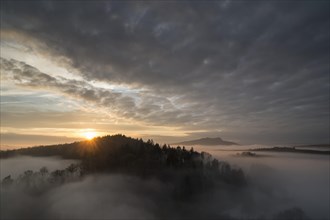 Sunset over volcanic landscape with fog