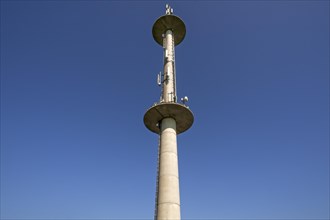 Transmission tower against blue sky