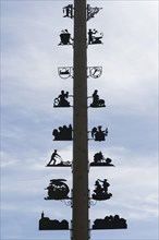 Maypole with signs of the local crafts