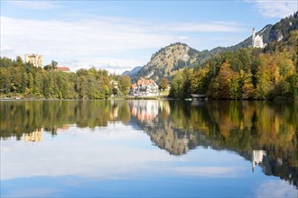 Alpsee lake with the royal castles of Schloss Neuschwanstein and Schloss Hohenschwangau in autumn