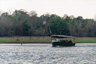 Tourists in safari boat on Kabini Reservoir