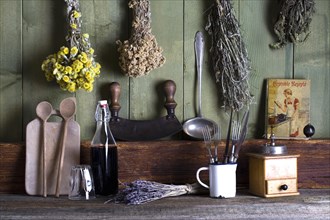Rustic kitchen still life with kitchen utensils and dried herbs