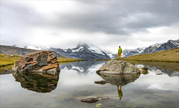 Hiker standing on rocks in the lake