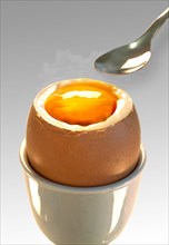 Soft-boiled egg with a spoon