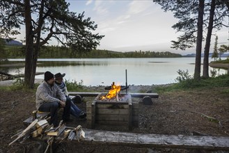 Couple sitting at a campfire