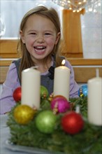 Girl enjoying the first lit candle on the Advent wreath
