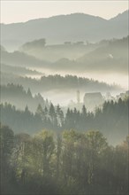 Morning mist over wooded hills