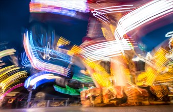 Scattered light trails from a fairground ride at night