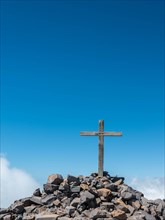 Summit cross of Pico de las Nieves against a blue sky