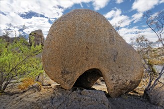 Round shaped huge granite rock with an erosed hole