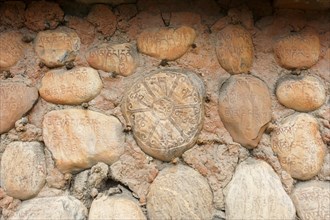 Mani stones with Tibetan inscriptions on wall