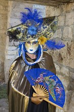 Woman wearing a Venetian mask and a costume