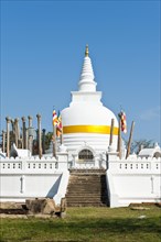 Old white stupa with orange ribbon