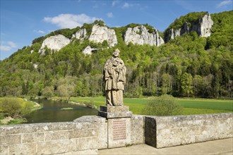 View of the Hausener Zinnen peaks and the statue of St. Nepomuk seen from Hausener Brucke bridge