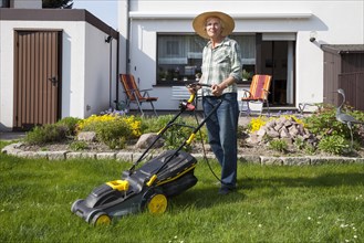 Woman mowing the lawn