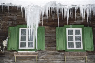Icicles above the windows of a hunting lodge
