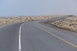 Omani highway through the sand desert