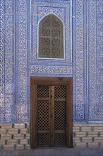 Door and mosaic-decorated wall