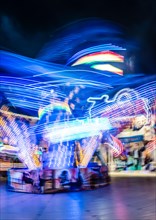 Scattered light trails from a fairground ride at night