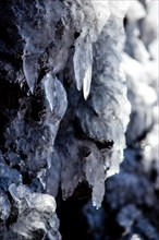 Water dripping from icicles on volcanic rock
