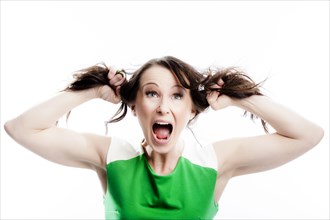 Screaming woman tearing at her own hair