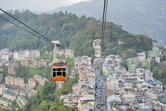 Gondola of a cable car and the town of Gangtok