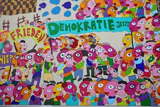 Colourful mural with the words 'Frieden' and 'Demokratie jetzt'