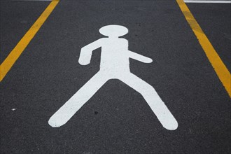 Pedestrian pictogram between parking spaces