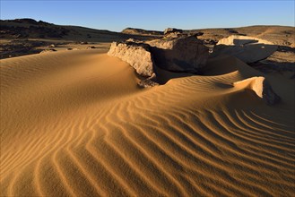 Sand dunes and sandblasted rocks on Tadrart plateau