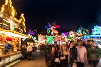 Festival visitors and rides at night