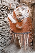 Animistic figure as a guard at the entrance to a house
