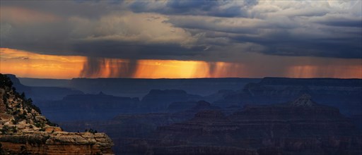 View of the Grand Canyon at sunset with storm clouds