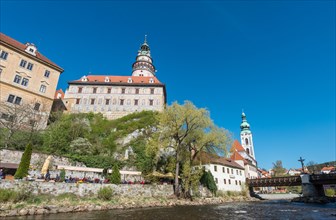 Cesky Krumlov Castle with its tower and the Church of St. Jost on the Vltava river