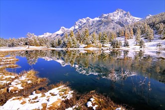Schwarzsee or Lai Nair with snow-covered larch forest