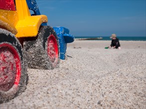 Toy digger on a beach