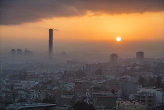 Sunrise over city with minaret of Great Mosque of Algiers
