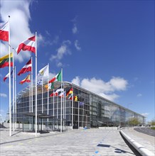 International flags waving in front of European Investment Bank