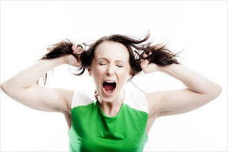 Screaming woman tearing at her own hair