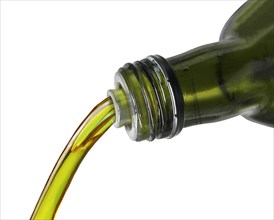 Olive oil pouring from a bottle