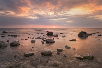 Stones at sunrise at the Baltic Sea coast