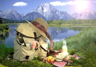 Filled hiking backpack in front of a mountain scenery and a lake