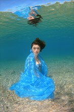 Underwater model presenting fashion in the sea