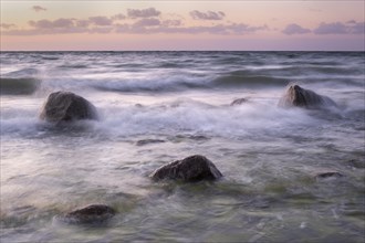 Stones washed by waves on the Baltic coast in the evening light