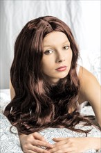 Woman wearing a wig in bed