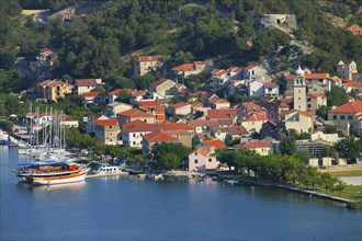 Townscape with sailing ship in the foreground