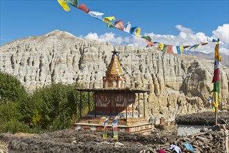 Colorful ornate Buddhist stupa with colorful prayer flags